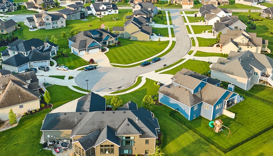 Aerial view of a planned neighborhood with detached single-family homes and driveways